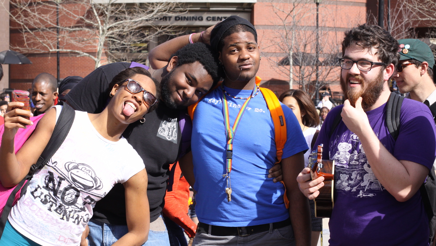 An ethnically diverse group of young male and female college students clowning for the camera